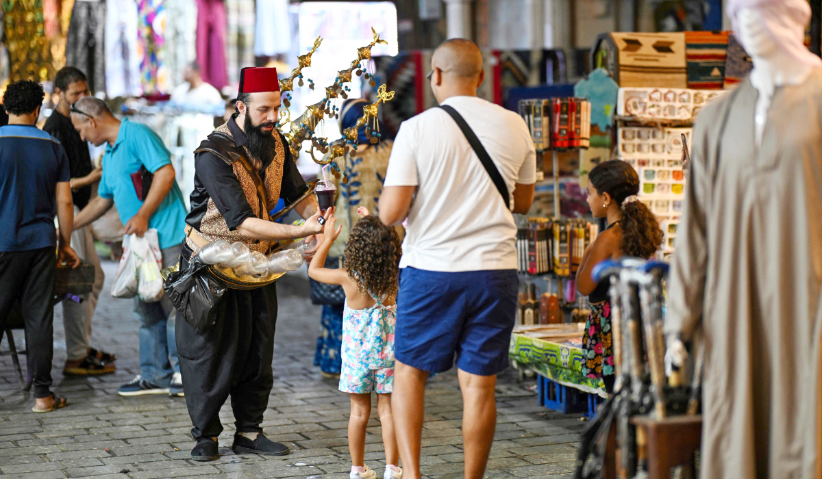 Syrian street vender Abou Ali sells juice at the Khan el-Khalili bazaar area in the old Islamic quarter of Cairo on August 29, 2024. (AFP)