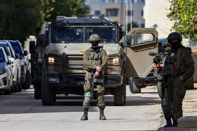 Israeli soldiers take positions during a raid in Ramallah in the occupied West Bank in December. (AFP/File)
