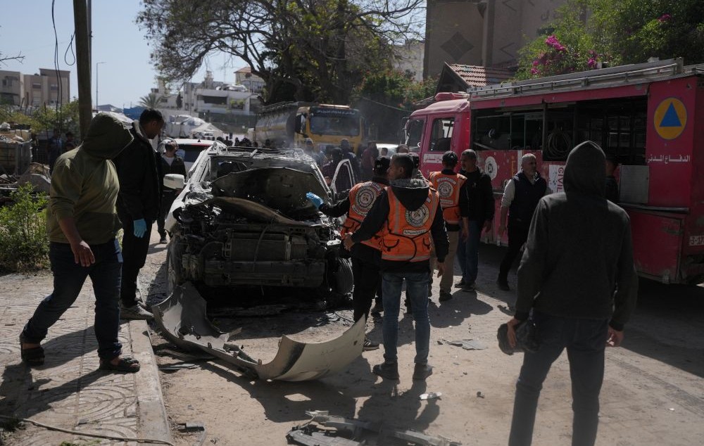 Palestinian civil defense crews work on a destroyed car after it was struck in an Israeli strike in Gaza City, Tuesday, April 28, 2026. (AP Photo)