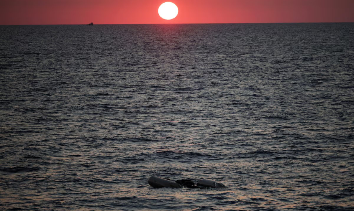 A rubber boat used by migrants floats at the sea on sunset in the Mediterranean, off Libya, August 9, 2025. (Reuters)