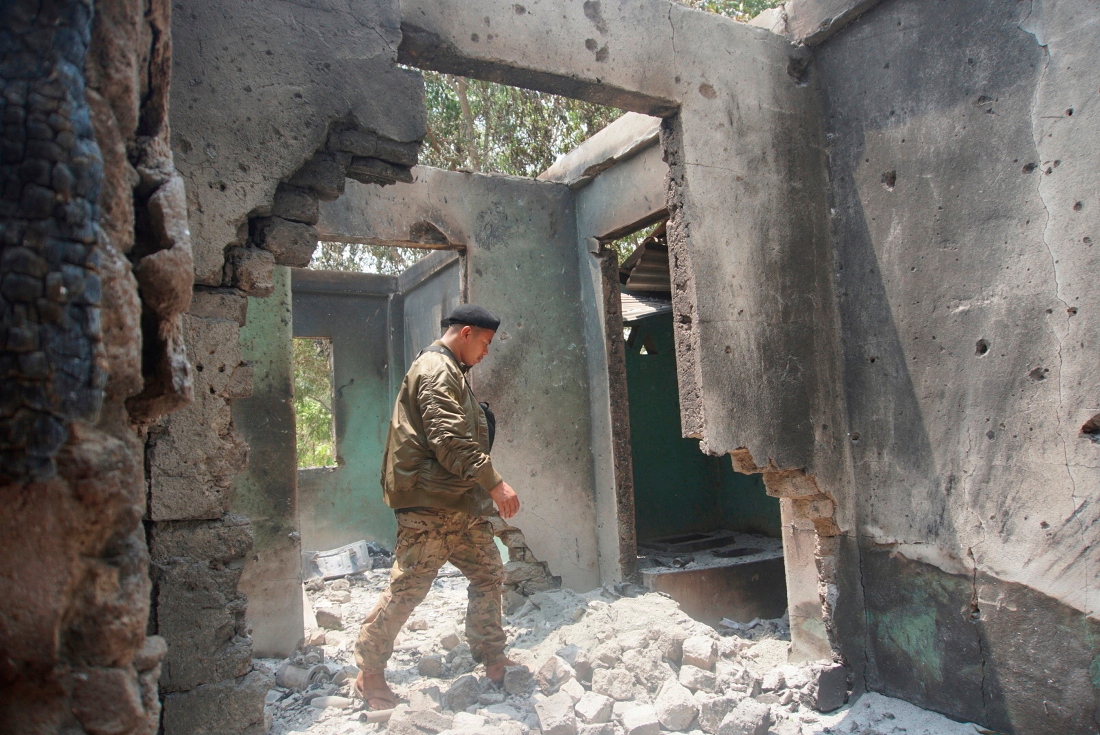 Saw Win Myint, a commander of a military unit under the Karen National Union inspects the damaged armory in the captured army base of Infantry Battalion 275 in Myawaddy township in Kayin state, Myanmar. (Metro)