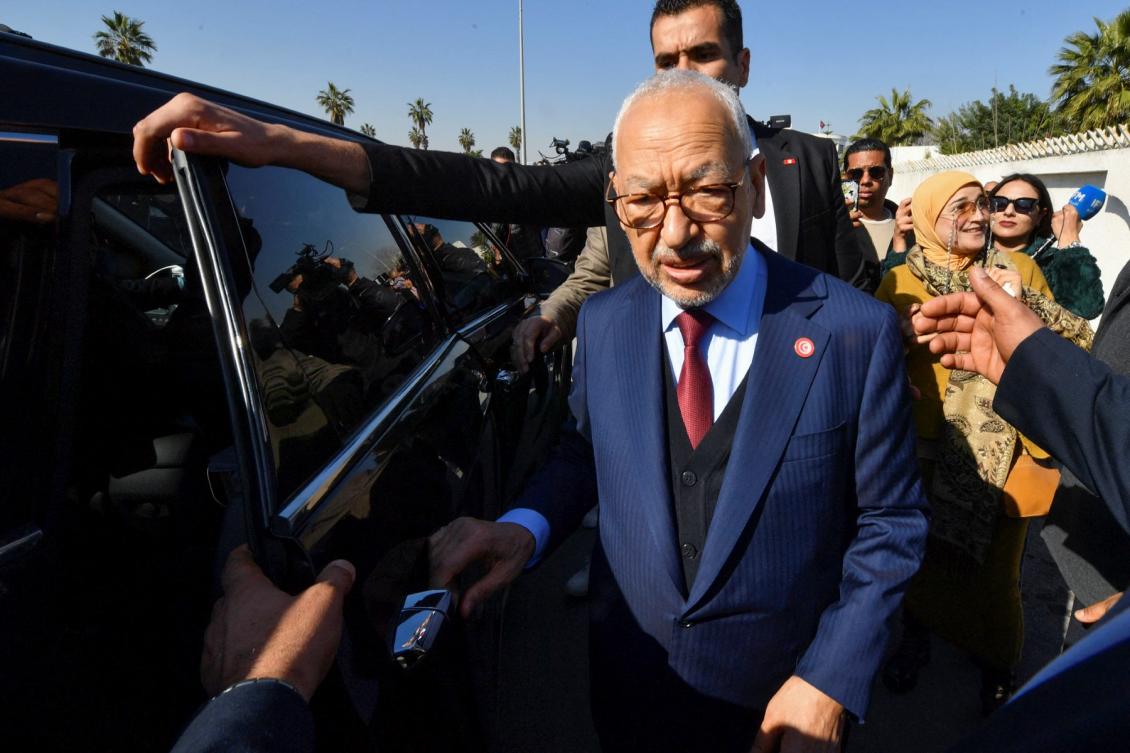 The head of Tunisia's Islamist movement Ennahdha Rached Ghannouchi greets supporters upon arrival to a police station in Tunis ,on February 21, 2023 (File/AFP)