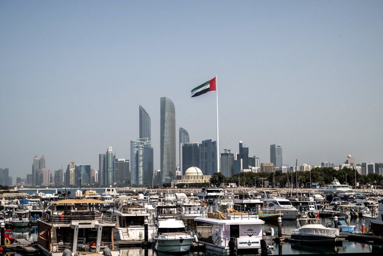 The United Arab Emirates flag flutters against the backdrop of the Abu Dhabi Skyline. (File/AFP)