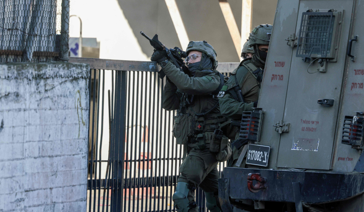 Israeli soldiers take positions during a military operation in West Bank city of Nablus on January 11, 2026. (AFP)