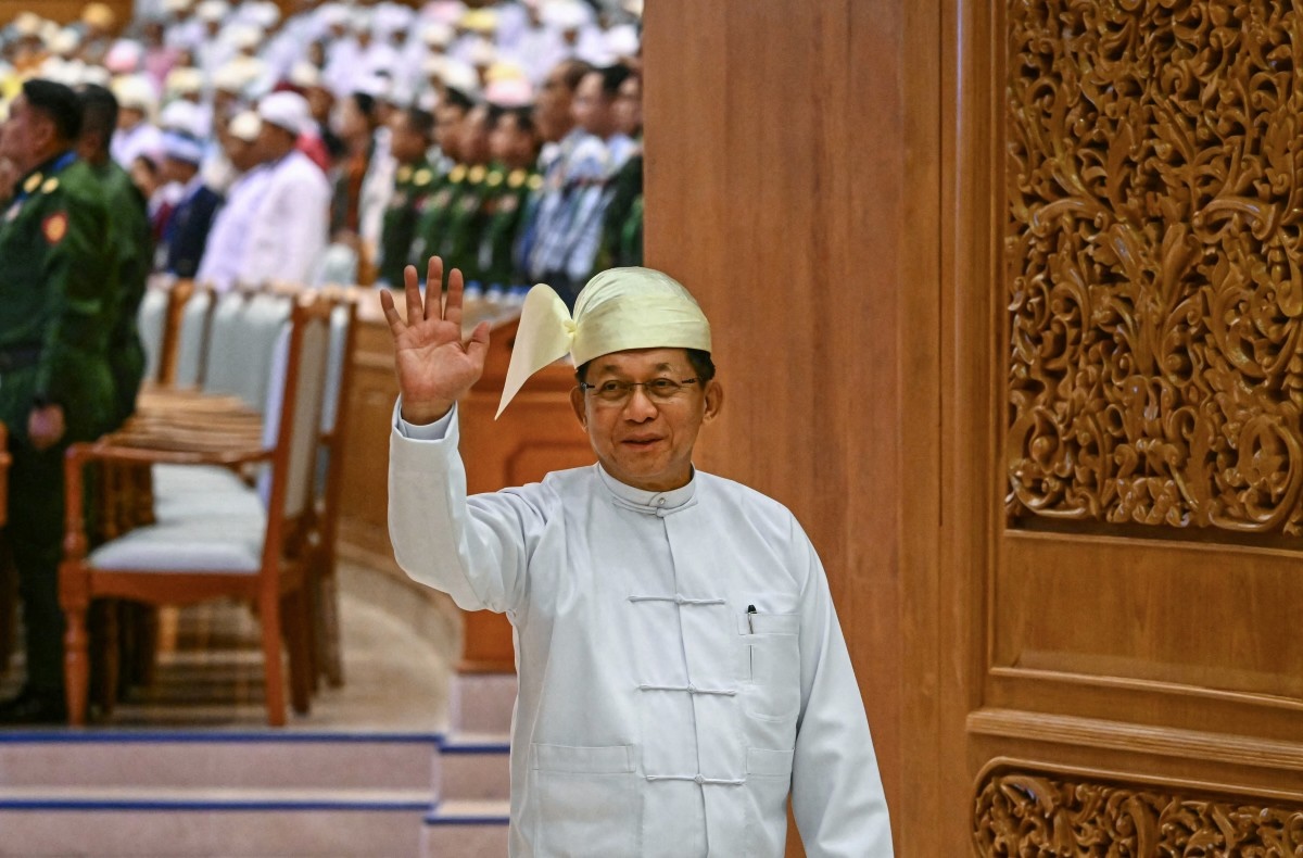 Former Myanmar military chief and Myanmar president Min Aung Hlaing waves as he leaves after the sworn-in ceremony. (File/AFP)