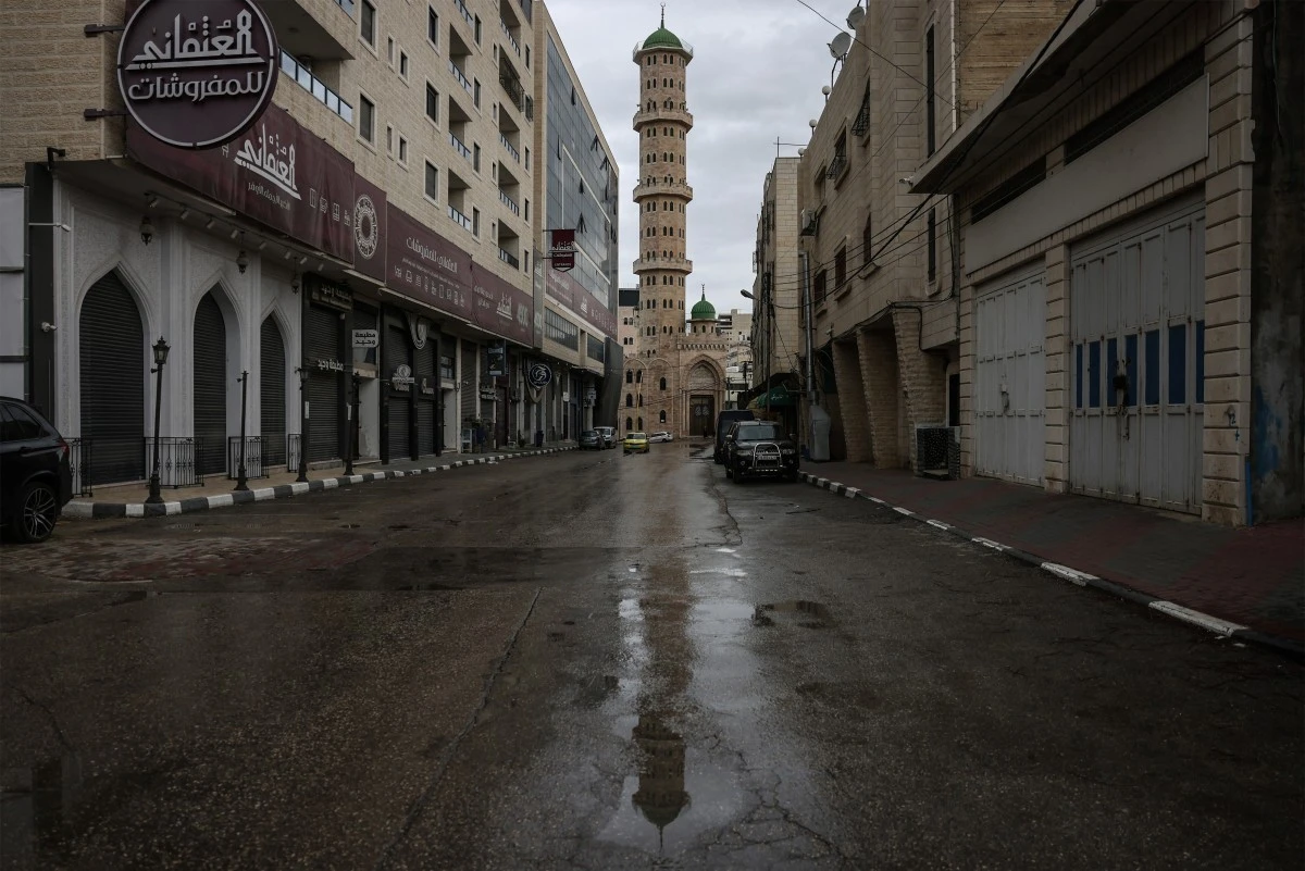 A photograph shows an empty street in Hebron, in the Israeli-occupied West Bank, during a general strike, April 1, 2026. (AFP)