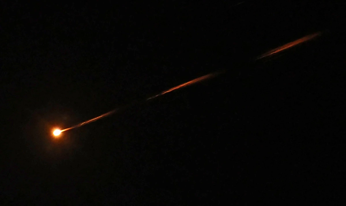 An Iranian missile streaks across the sky over Jerusalem. (AFP)