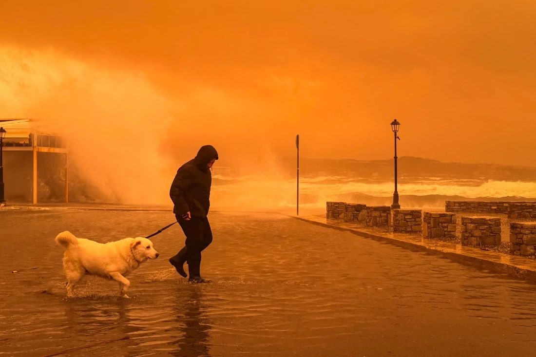 A local resident walks on the port of Ierapetra during a dust storm on the Greek island of Crete. (AFP)