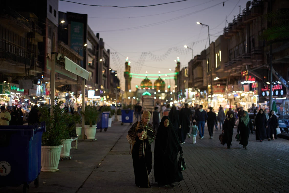 Muslim women walk at a local market near the Kadhimiya Shrine at dusk in the Shiite neighbourhood in Baghdad, Iraq, Tuesday, March 31, 2026. (AP)