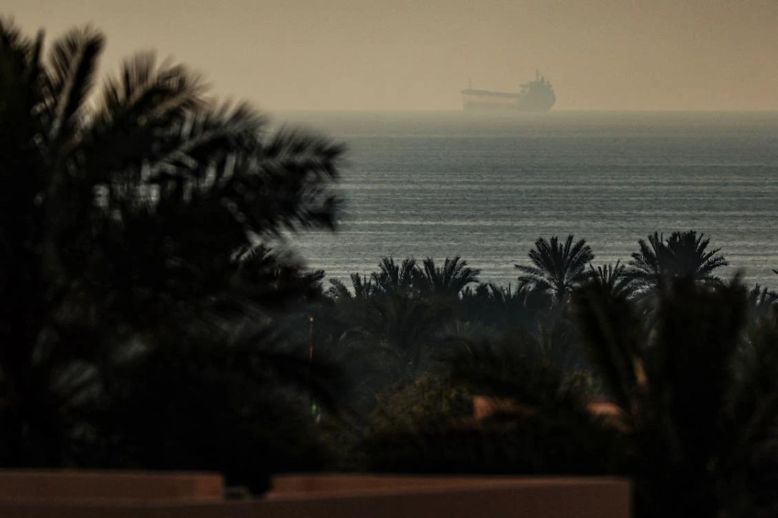 A photograph taken from the town of Al Jeer in the northern emirate of Ras Al Khaimah shows a tanker passing through the waters of the Strait of Hormuz on February 25, 2026. (FILE/AFP)