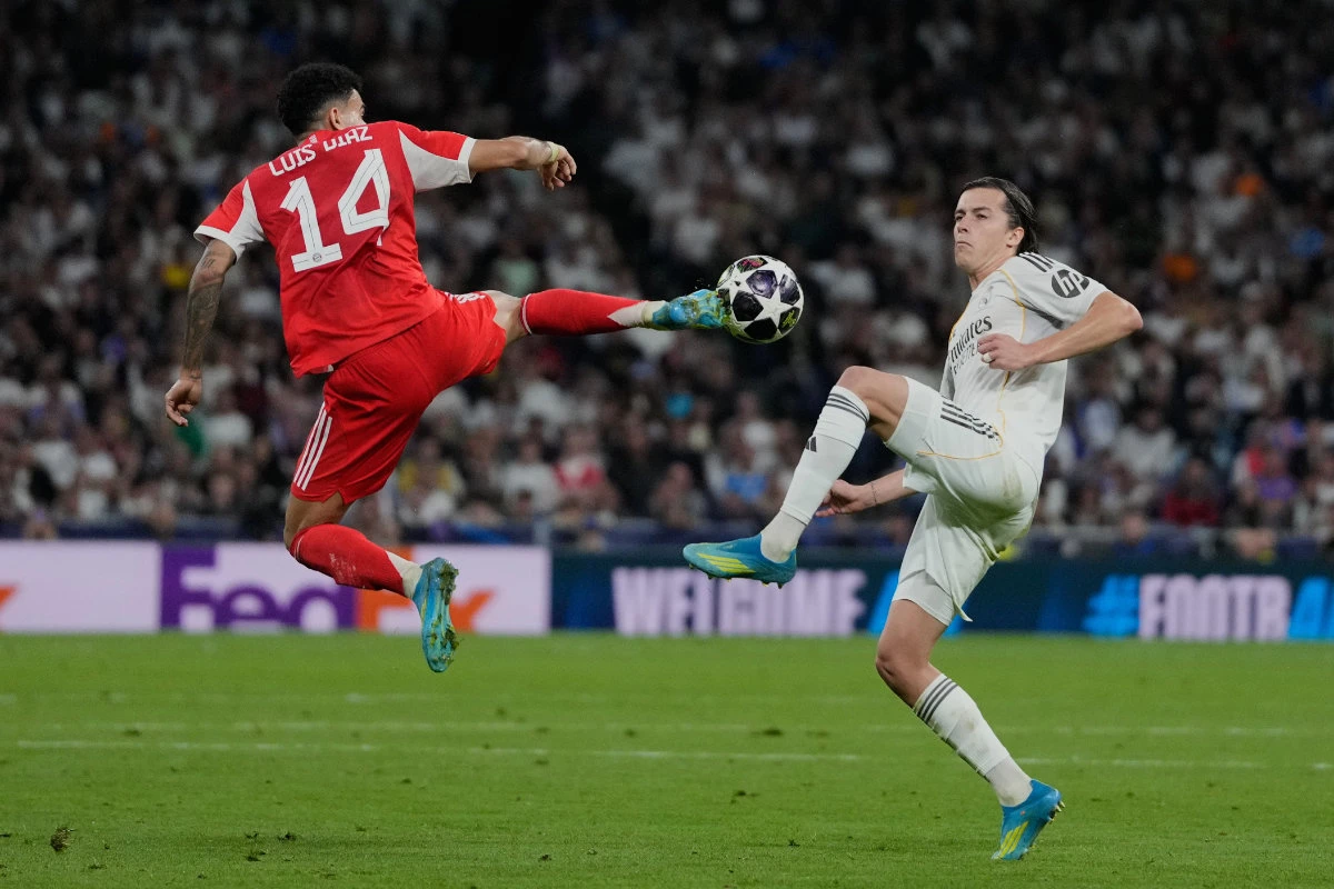 Real Madrid's Alvaro Carreras, right, and Bayern's Luis Diaz challenge for the ball during the Champions League quarterfinal first leg soccer match between Real Madrid and Bayern Munich in Madrid, Spain, Tuesday, April 7, 2026. (AP)