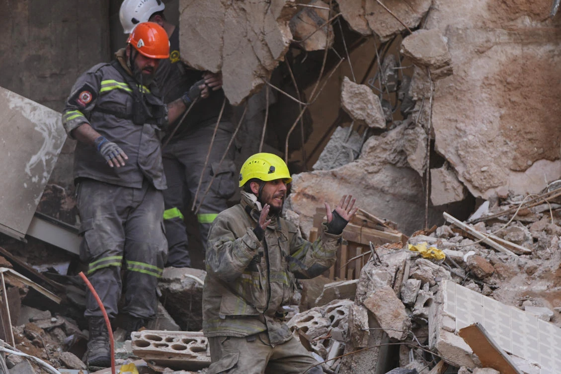 A rescuer gestures as others search for victims in the rubble of a building destroyed in an Israeli airstrike a day earlier in central Beirut, Lebanon, Thursday, April 9, 2026. (AP)