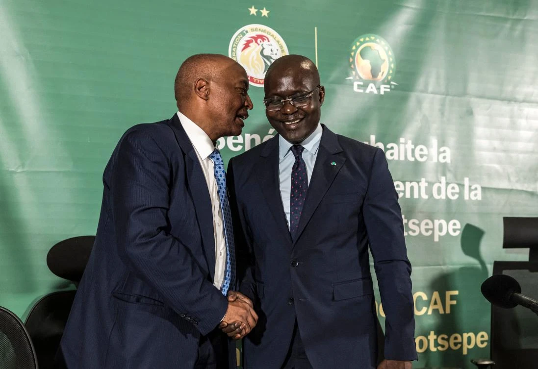 President of Confederation of African Football (CAF) Patrice Motsepe speaks with the president of the Senegalese Football Federation (SFS) Abdoulaye Fall (R) at the end of a press conference at the Pullman Hotel in Dakar on Apr. 8, 2026. (AFP)