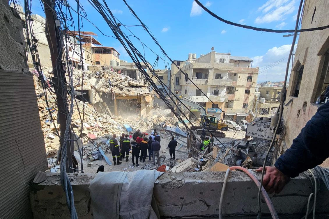Workers clear rubble from the site of an Israeli airstrike the day before that targeted the Bir Hassan neighborhood in Beirut’s southern suburbs on April 9, 2026. (AFP)