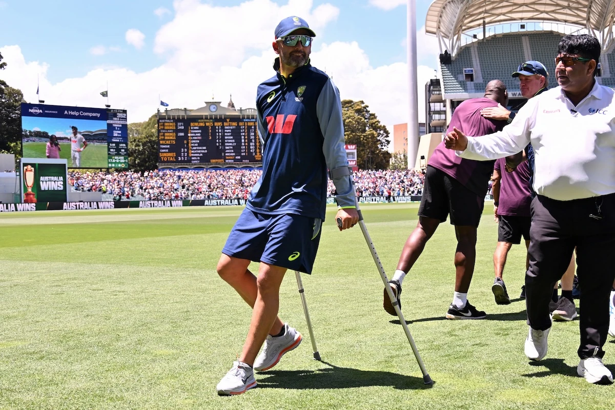 Australia's Nathan Lyon walks with the aid of crutches after play on the final day of the third Ashes cricket Test match between Australia and England at the Adelaide Oval in Adelaide on December 21, 2025. (FILE/AFP)