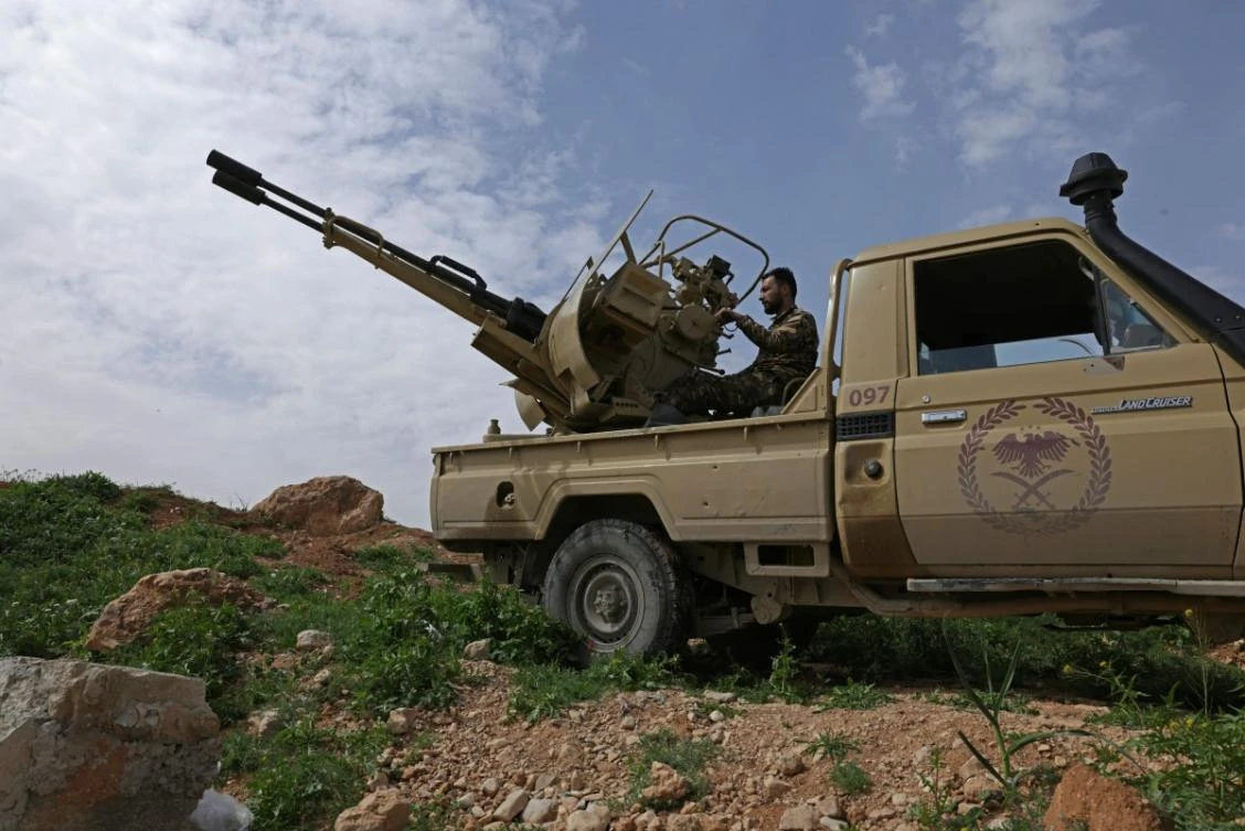 A Syrian army soldier operates an armoured vehicle positioned along the Syrian–Lebanese border in the rural area of Al Qusayr on April 1, 2026. (AFP)