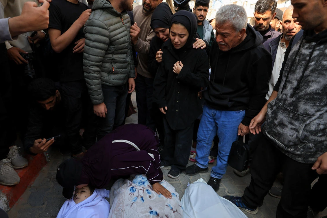Palestinians hold funerals for pregnant woman and her children killed in Israeli strikes