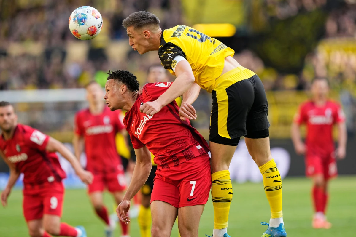 Dortmund down Freiburg to seal Champions League spot