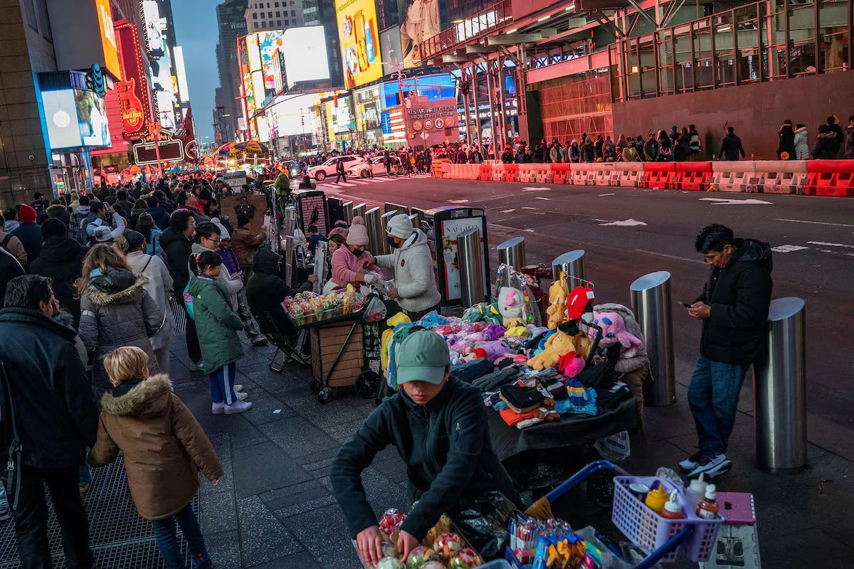 People display merchandise for pedestrians around Times Square, in New York, US. (Reuters)