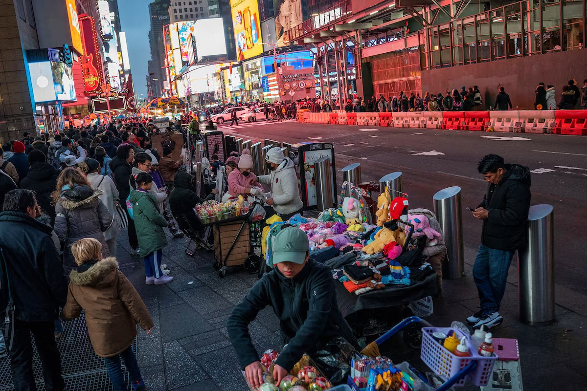 People display merchandise for pedestrians around Times Square, in New York, US. (Reuters)