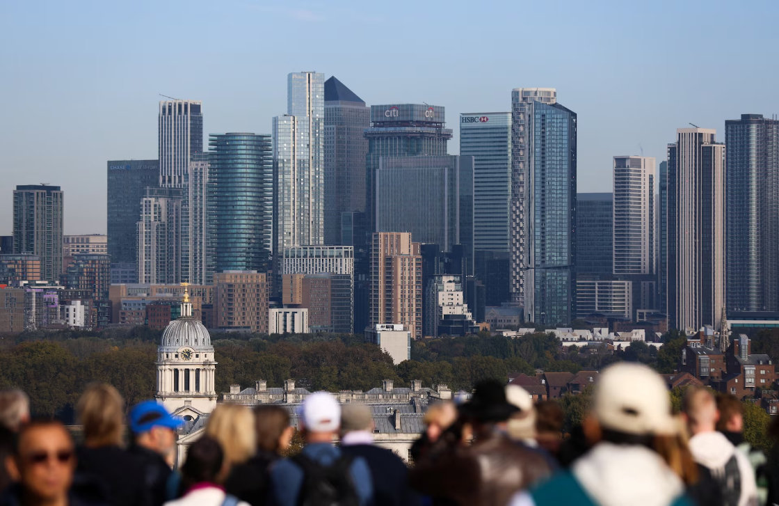 Tourists gather at the General Wolfe Statue viewpoint overlooking Canary Wharf, in Greenwich Park, London, Britain. (Reuters)