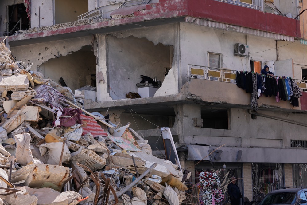 A woman hangs laundry in her damaged apartment after returning home with her family in the southern port city of Tyre, Lebanon, Thursday, April 30, 2026. (AP)