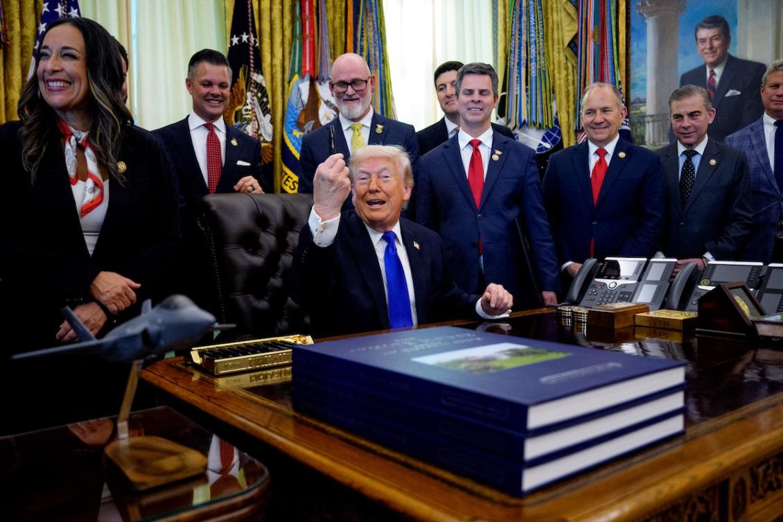 President Donald Trump, accompanied by Republican members of Congress, holds up a pen as he speaks to reporters after signing executive orders in the Oval Office of the White House on April 30, 2026 in Washington, DC. (FILE/AFP)