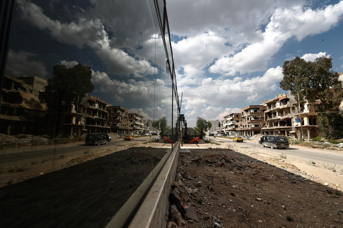 Vehicles drive past damaged buildings in the Yarmouk refugee camp on the outskirts of Damascus, Syria, Apr. 29, 2026 in an area that was heavily bombed by forces loyal to former Syrian President Bashar Assad during the Syrian war. (AP)