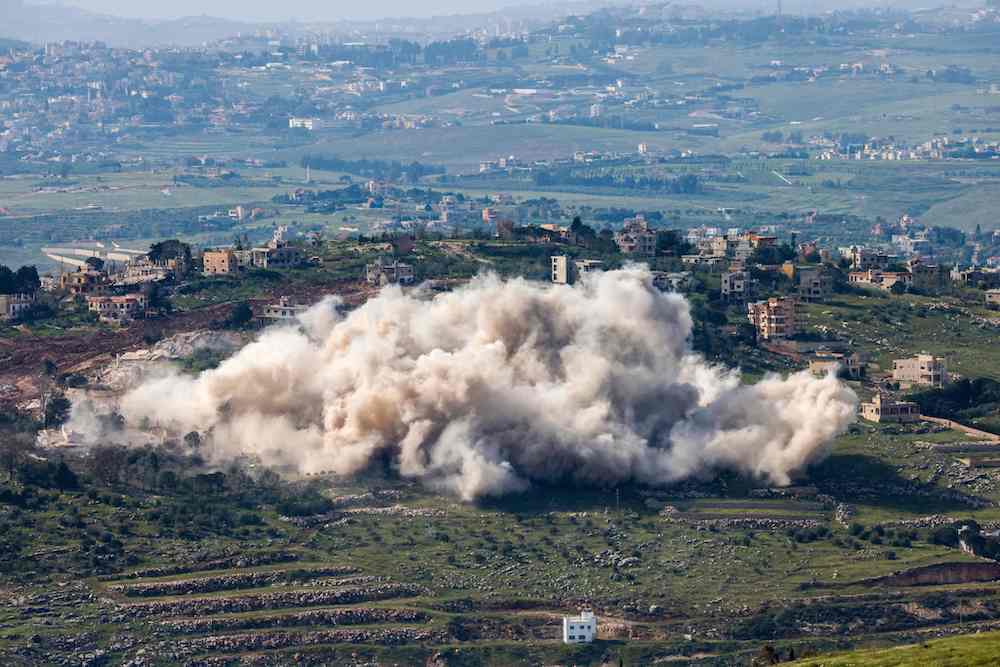 This picture taken from a position in Upper Galilee in northern Israel, near the border with Lebanon, shows smoke rising as the Israeli army demolishes buildings and homes in southern Lebanon. (AFP/File Photo)