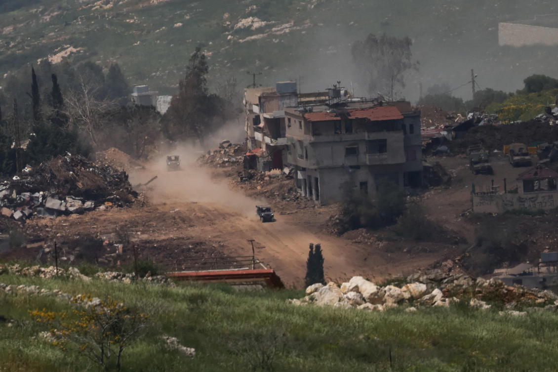 Israeli military vehicles move next to damaged buildings in southern Lebanon, near the Israel-Lebanon border, as seen from northern Israel, Apr. 27, 2026. (Reuters)