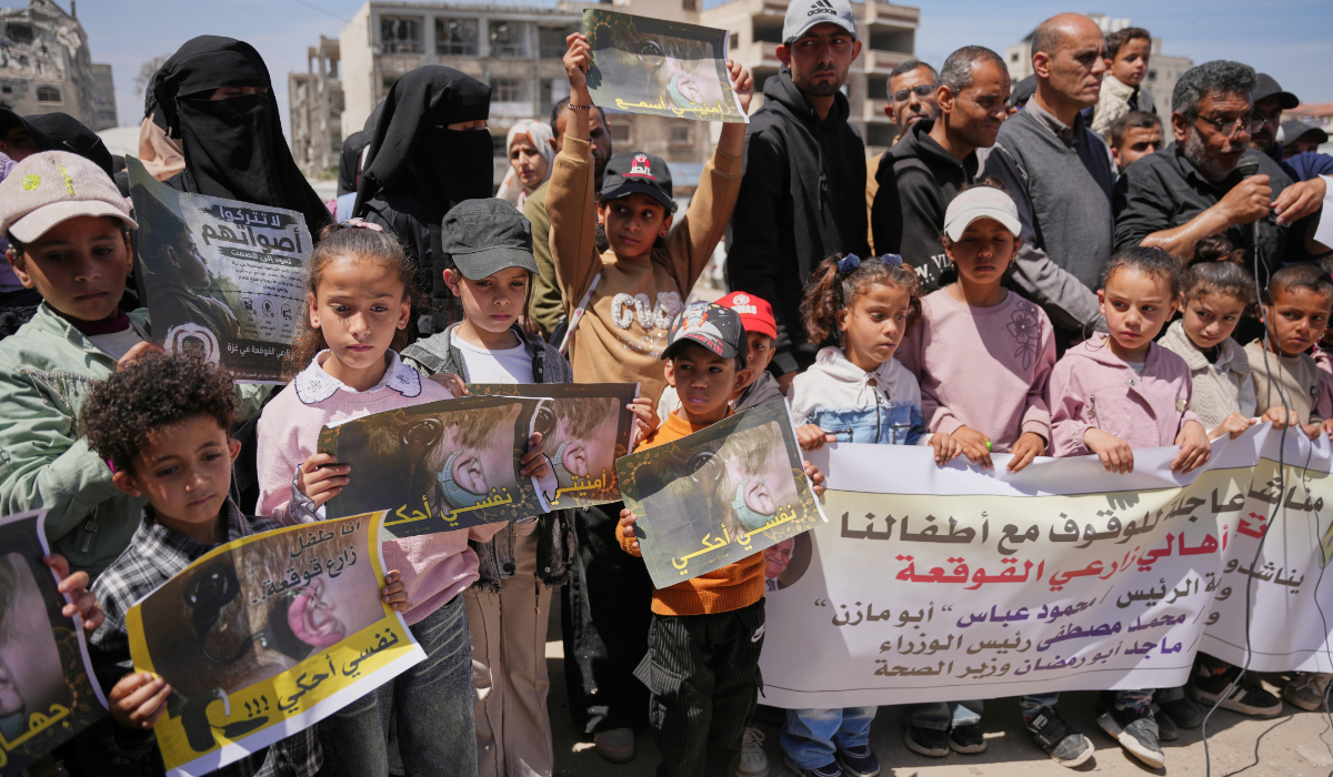 Palestinians take part in a protest in Gaza against the limited access to medical spare parts and batteries for deaf and hearing-impaired individuals. (AP)