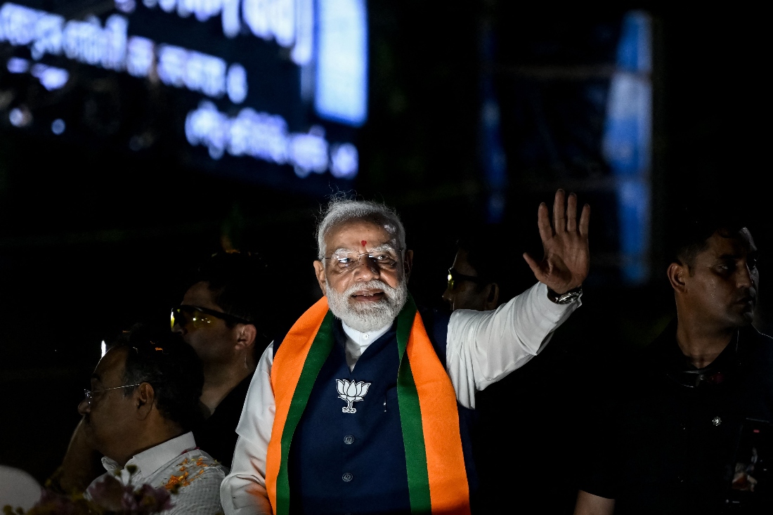 India's Prime Minister Narendra Modi greets his supporters during a roadshow in Kolkata, India. (AFP)