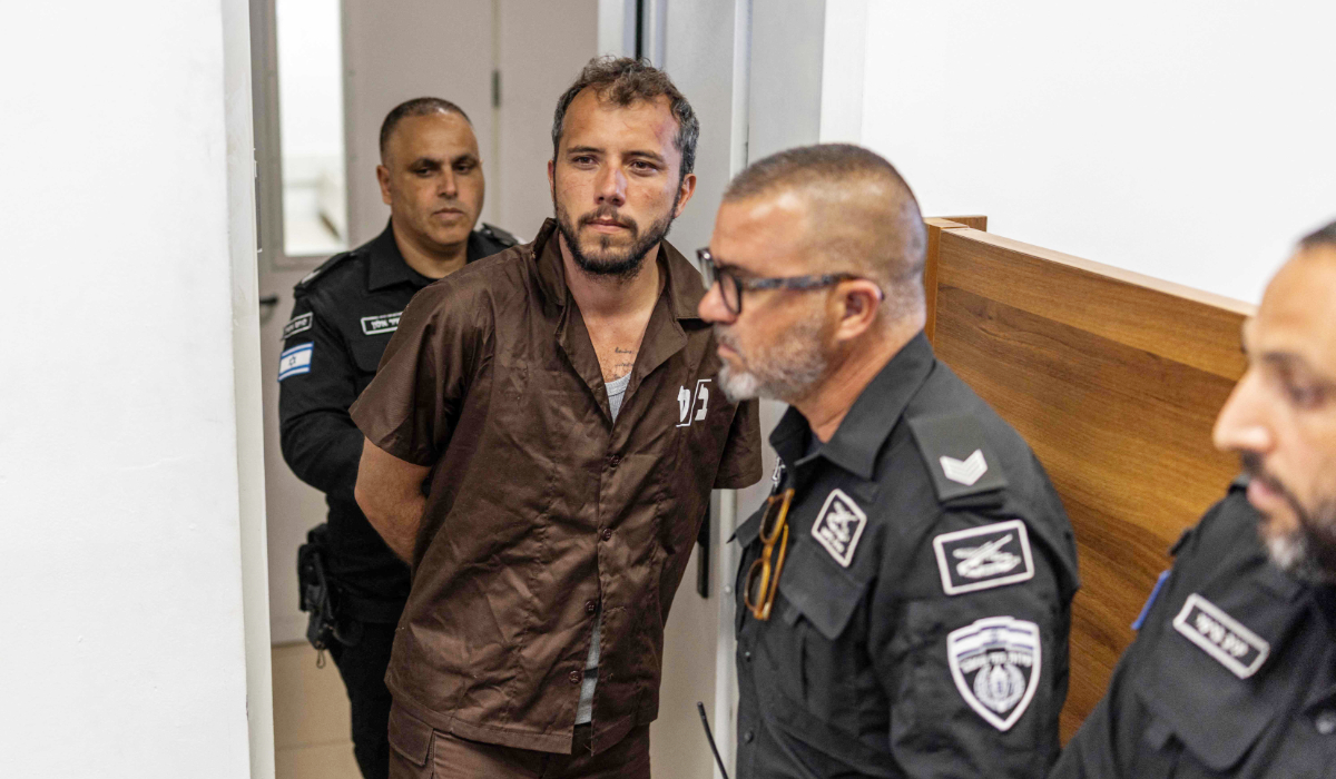 Security personnel escort Brazilian activist Thiago Avila to a court in Ashkelon on May 3, 2026. (AFP)