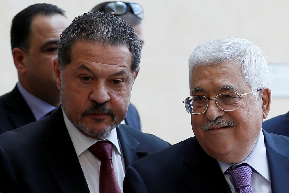 Yasser Abbas. left, with his father. (Reuters/File)
