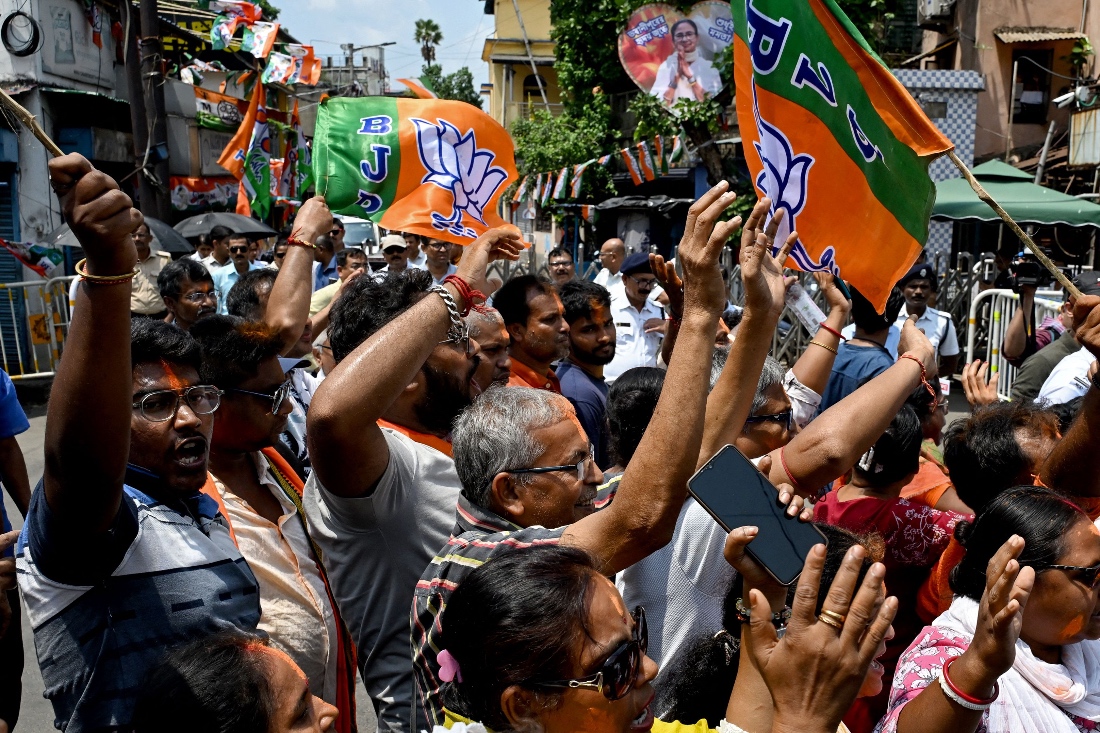 Bharatiya Janata Party (BJP) supporters celebrate after taking a lead during vote counting for the West Bengal Legislative Assembly elections in Kolkata, India. (AFP)