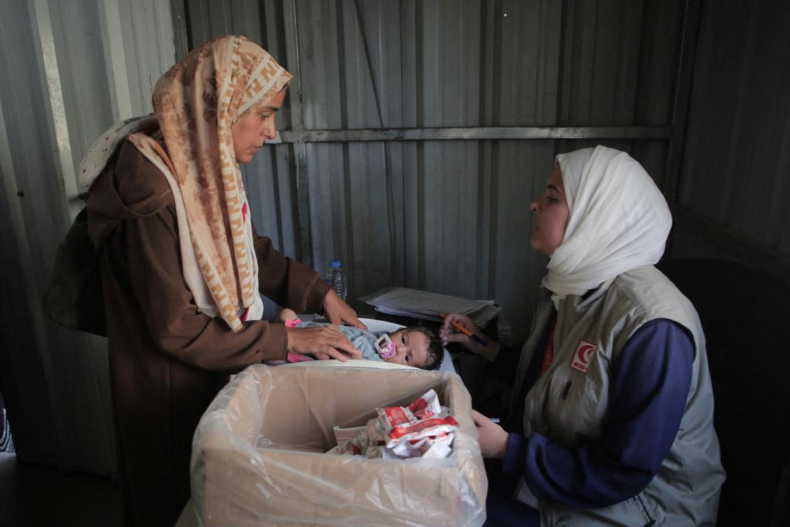 Above, a Palestinian infant gets a medical checkup at an infirmary in Al-Mawasi in the southern Gaza Strip district of Khan Younis on Aug. 13, 2025. An MSF analysis showed significantly higher levels of prematurity and mortality among infants born to malnourished mothers. (AFP)