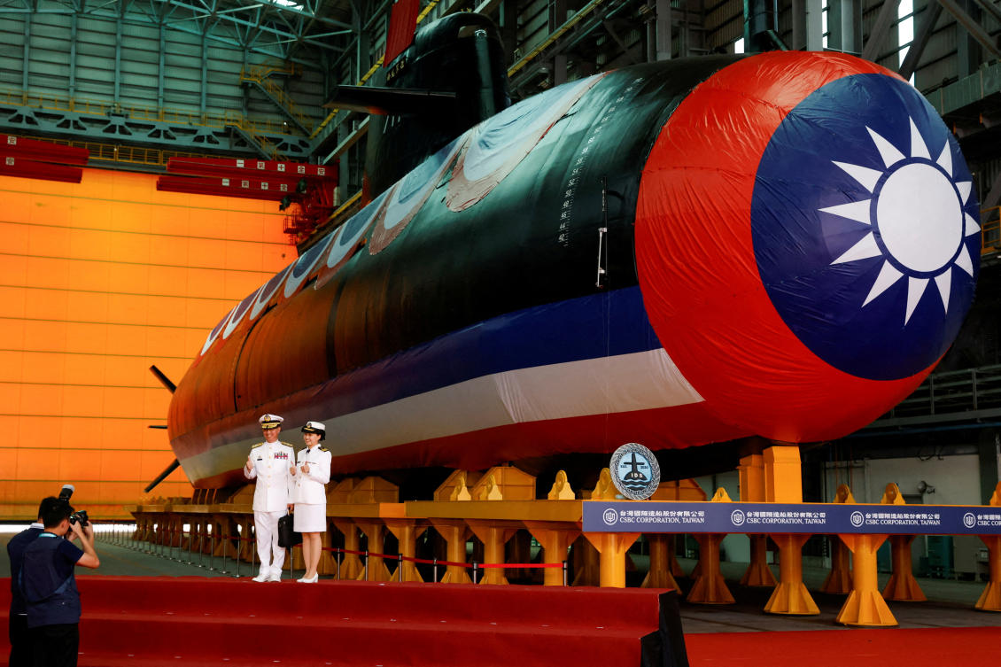 Members of the navy pose for pictures next to Narwhal, Taiwan's first domestically built submarine, after its launching ceremony in Kaohsiung, Taiwan September 28, 2023. (REUTERS)