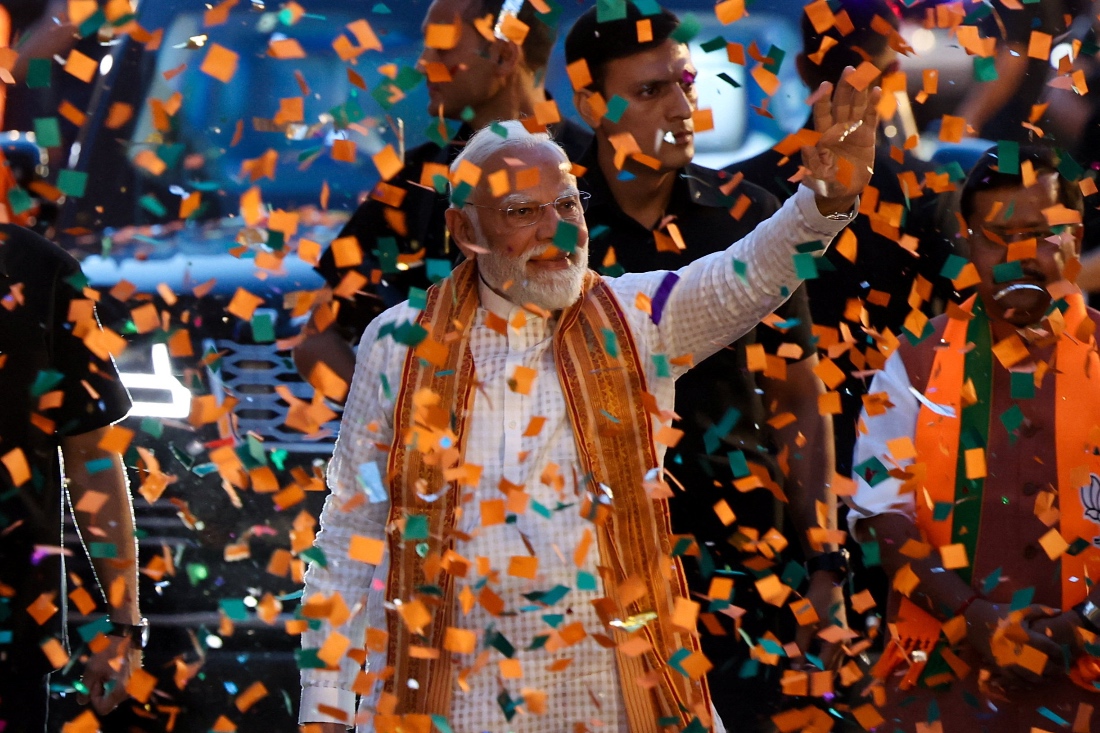 India's Prime Minister Narendra Modi greets his supporters as he arrives at the Bharatiya Janata Party (BJP) headquarters in New Delhi, India. (Reuters)