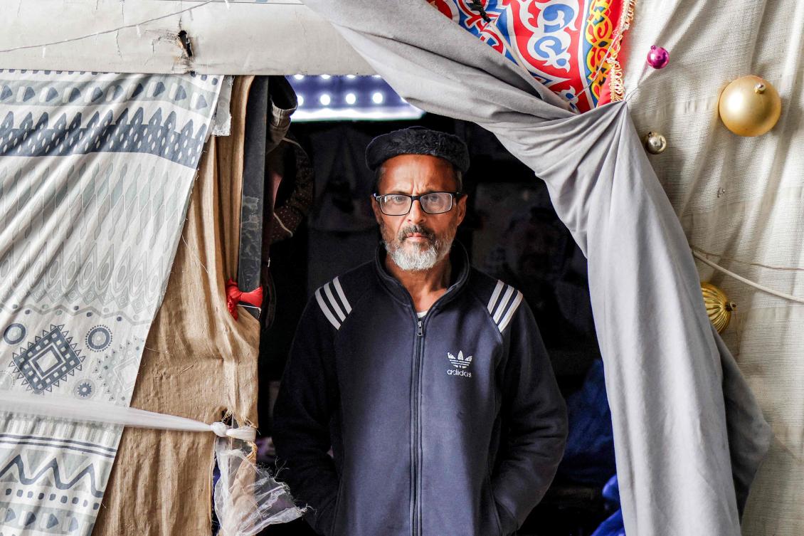 Under the bleachers of a West Bank stadium, a dozen men from Gaza live in a former changing room, blocked from returning home by the war that erupted more than two and a half years ago. (AFP)