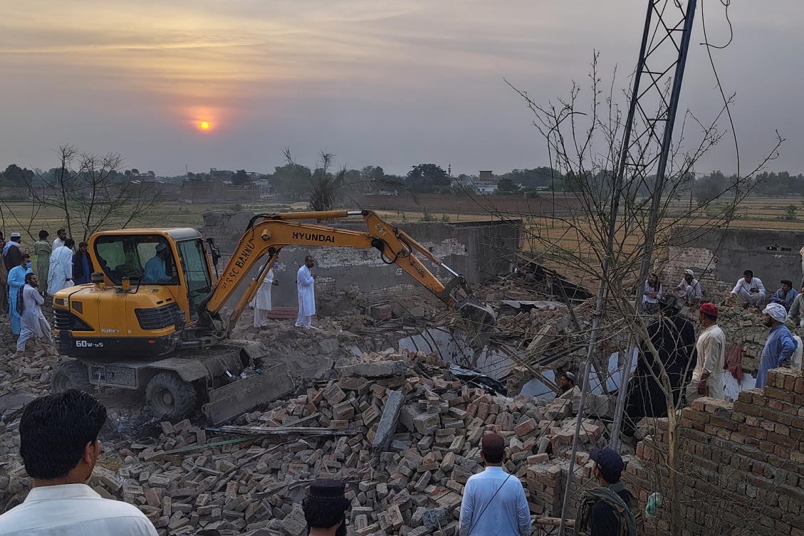 A worker clears rubble at the site of overnight suicide bombing at a security post in Bannu, a district in Pakistan’s Khyber Pakhtunkhwa province bordering Afghanistan on May 10, 2026. (AP)