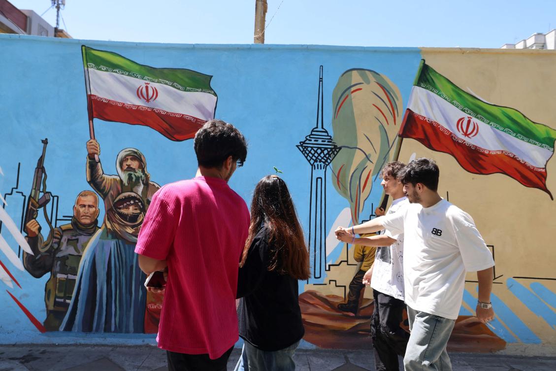 Iranians walk past an anti-US and anti-Israel mural painted on a wall in the capital Tehran on May 10, 2026. (FILE/AFP)