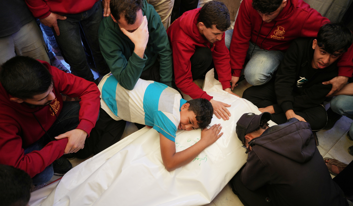 A Palestinian boy Baraa Heikal mourns over the body of his brother Fadi Heikal, who was killed in an Israeli strike, during his funeral at Nasser Hospital in Khan Younis, southern Gaza Strip, Sunday, May 10, 2026. (AP)