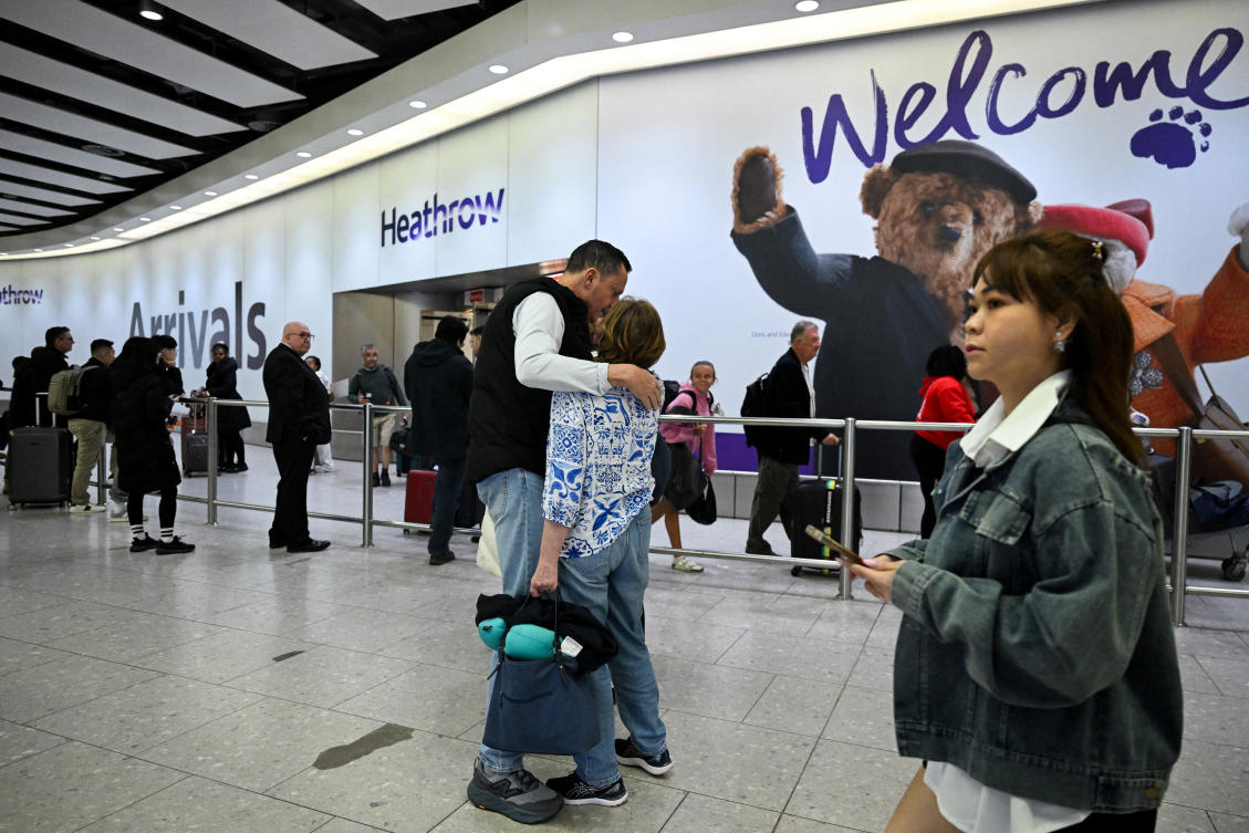FILE PHOTO: A passenger from an Oman Air flight which departed from Muscat, Oman, is welcomed upon arrival at Heathrow International Airport, amid the U.S.-Israeli conflict with Iran, in London, Britain, March 6, 2026. (Reuters)