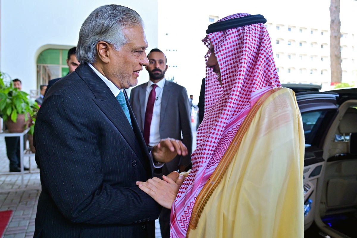 This handout photograph taken on March 29, 2026 and released by Pakistan's Ministry of Foreign Affairs shows Pakistan's Foreign Minister Ishaq Dar (L) greeting his Saudi Arabian counterpart Faisal bin Farhan, upon his arrival at the Foreign Ministry office in Islamabad. (AFP)