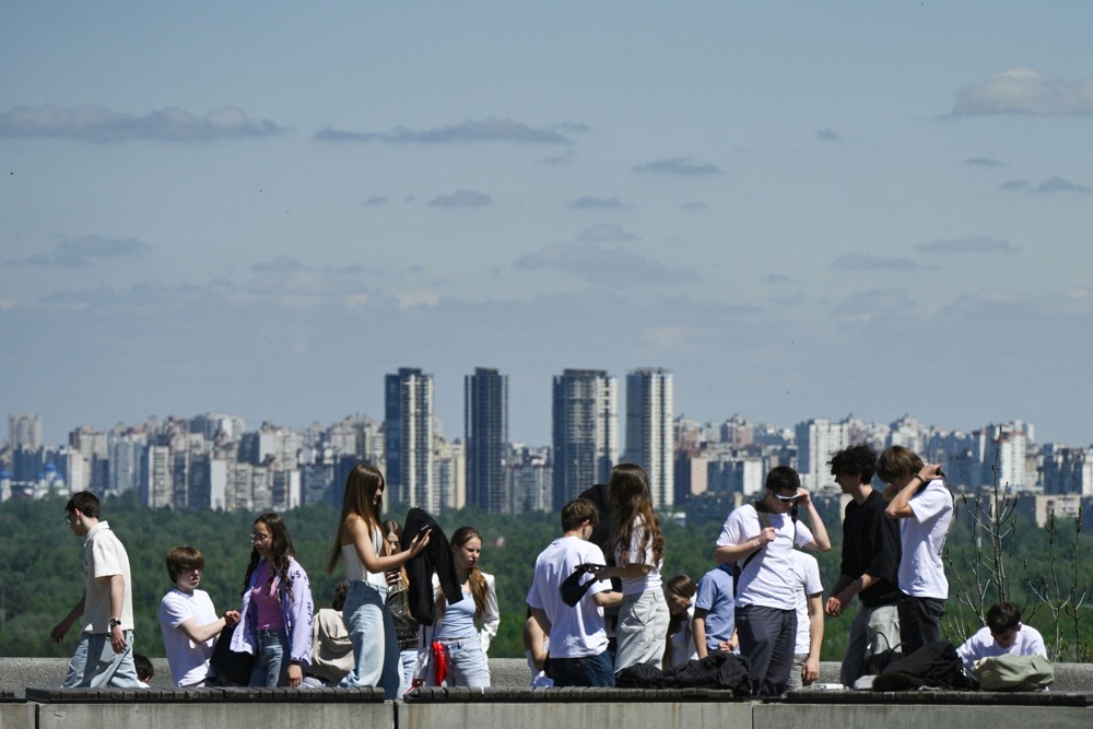 People enjoy the sun in a park in central Kyiv on May 11, 2026, amid the Russian invasion of Ukraine. (AFP)