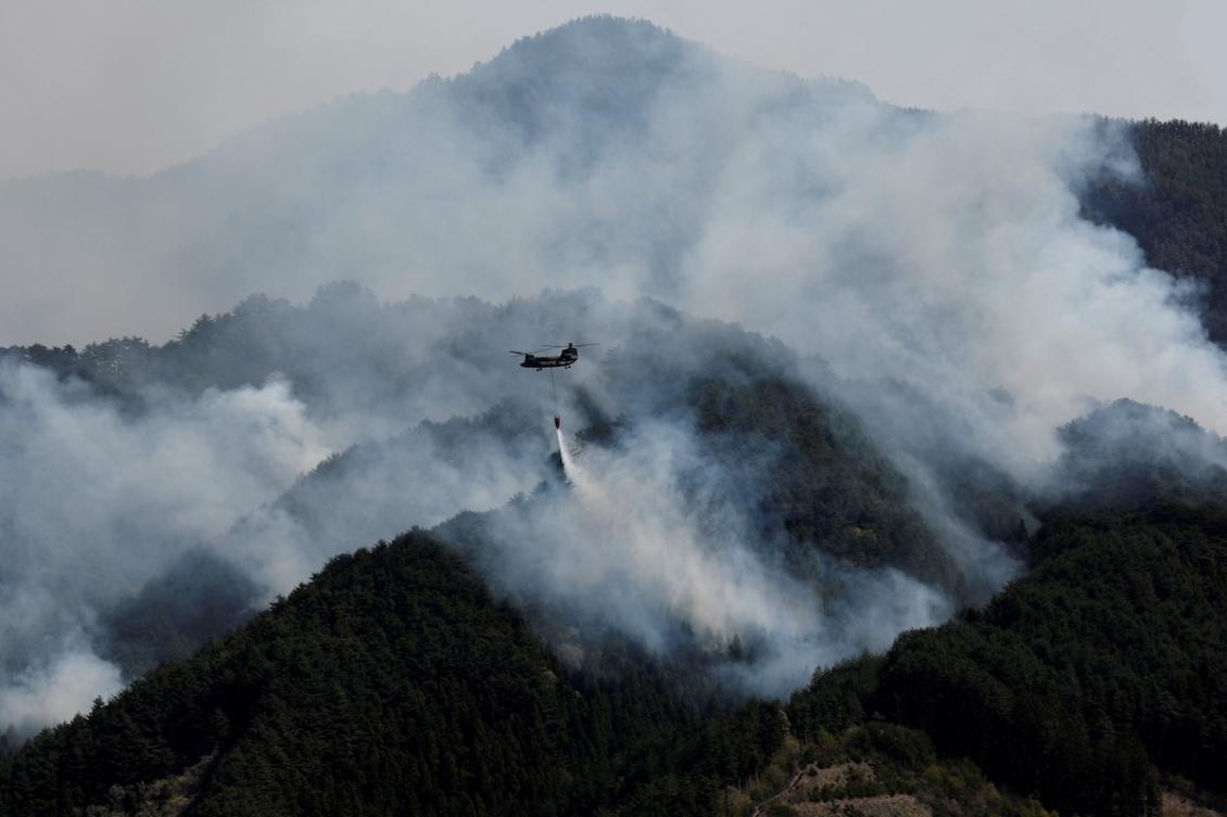 Above, helicopter conducts firefighting operations as wildfires continue in Otsuchi, Iwate Prefecture, Japan on April 26, 2026. Asian fires have burned as much as 44 million hectares of land so far this year. (Reuters)