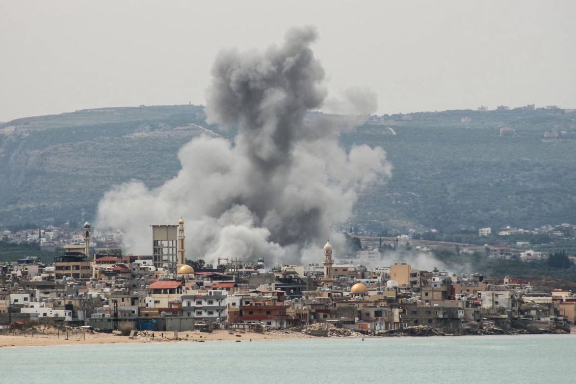 A photograph taken from the southern area of Tyre shows smoke rising from the site of an Israeli airstrike that targeted the area of Ras Al-Ain on May 12, 2026. (AFP)