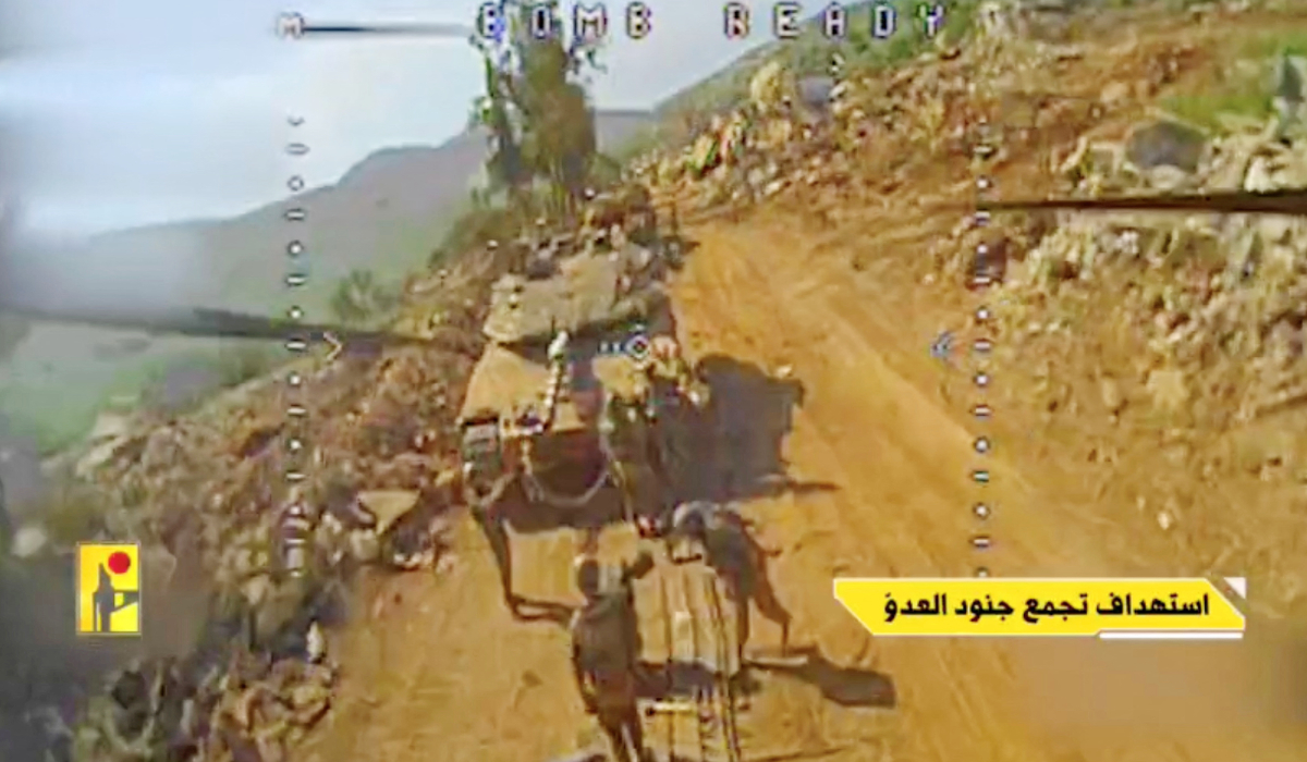 A screengrab from a Hezbollah video shows Israeli soldiers gathered moments before being hit by an FPV drone in Taybeh, Lebanon. (Reuters)