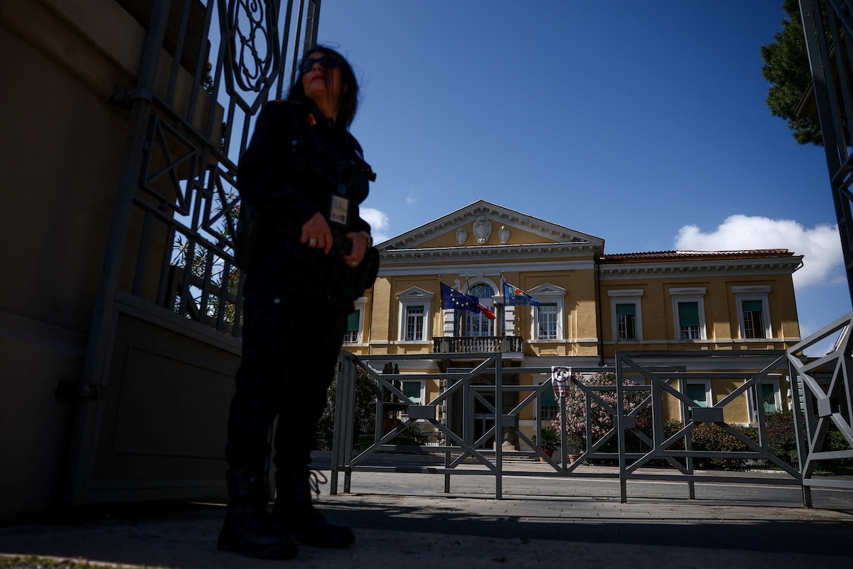 Above, a security guard stands near the entrance to the Spallanzani infectious disease hospital in Rome where biological samples from an Italian man placed in quarantine was examined. (Reuters)