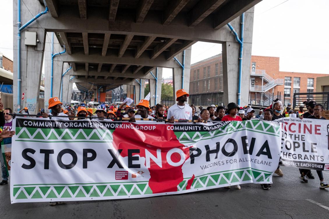 South African and foreign migrants hold banner and shout slogan during a demonstration against xenophobia in Johannesburg, on March 26, 2022 organized by the activist movement against xenophobic attacks Kopanang Africa. (File/AFP)